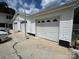 Exterior showcasing a multi-car garage with white doors and a spacious driveway at 201 Mitchell St, Belmont, NC 28012