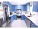 Bright kitchen featuring stylish blue cabinets, stainless steel appliances, and elegant white countertops at 201 Mitchell St, Belmont, NC 28012