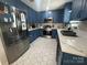 Updated kitchen featuring blue cabinets, stainless steel appliances, and white countertops at 201 Mitchell St, Belmont, NC 28012