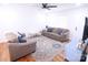 Bright living room featuring hardwood floors, a ceiling fan, and neutral-toned furnishings at 201 Mitchell St, Belmont, NC 28012