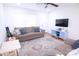 Bright living room with neutral walls, plush sofa, and stylish rug, creating a comfortable and inviting space at 201 Mitchell St, Belmont, NC 28012