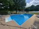 Large in-ground pool surrounded by a fenced yard at 201 Mitchell St, Belmont, NC 28012