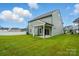 Large, flat backyard with green grass featuring a covered patio and neutral siding on the home at 2020 Embassy Ct # 48, Charlotte, NC 28213