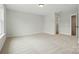 A spacious bedroom with neutral carpet and trim, featuring an ensuite bathroom and walk-in closet at 2020 Embassy Ct # 48, Charlotte, NC 28213