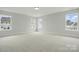 Spacious bedroom with neutral carpet, white trim, and multiple windows at 2020 Embassy Ct # 48, Charlotte, NC 28213