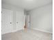 Bedroom with neutral walls and plush carpeting, offering a peaceful space to relax and rejuvenate at 2020 Embassy Ct # 48, Charlotte, NC 28213