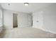A bright bedroom with neutral carpet and trim, featuring double closets and entry to the bathroom at 2020 Embassy Ct # 48, Charlotte, NC 28213