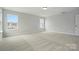 Bright bedroom featuring plush carpet, crisp white trim, and abundant natural light at 2020 Embassy Ct # 48, Charlotte, NC 28213