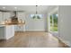 Modern kitchen and dining area features an island and access to the outdoors through sliding glass doors at 2020 Embassy Ct # 48, Charlotte, NC 28213