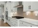 Bright kitchen features white cabinets, modern backsplash, stainless steel range hood, and built-in oven at 2020 Embassy Ct # 48, Charlotte, NC 28213
