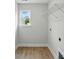 A practical laundry room with a single window and white wire rack storage system at 2020 Embassy Ct # 48, Charlotte, NC 28213