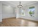 Bright living room with many windows, decorative molding, and wood flooring at 2020 Embassy Ct # 48, Charlotte, NC 28213