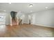 Open-concept living room with hardwood floors and stairs leading to the upper level, fostering a cozy atmosphere at 2020 Embassy Ct # 48, Charlotte, NC 28213
