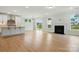 Open concept living space featuring a kitchen island, fireplace, and sliding door to yard at 2020 Embassy Ct # 48, Charlotte, NC 28213