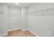 Walk-in closet with neutral carpet, white trim, and shelving for optimal storage at 2020 Embassy Ct # 48, Charlotte, NC 28213