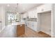 Bright kitchen with quartz countertops, stainless steel appliances, island with sink, and natural light at 204 Mattoon St, Charlotte, NC 28216