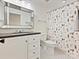 Bathroom featuring a tiled floor, a vanity with black countertop, and shower with a whimsical dog-themed curtain at 2417 Calais Pl, Charlotte, NC 28211
