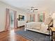 Inviting bedroom featuring hardwood floors, natural light, neutral colors, and a decorative ceiling fan at 2417 Calais Pl, Charlotte, NC 28211