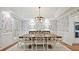 Elegant dining room featuring decorative wallpaper, modern lighting, and seating for eight at 2417 Calais Pl, Charlotte, NC 28211