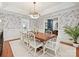 Formal dining room with bird-themed wallpaper, wood table with seating for eight, and hardwood floors at 2417 Calais Pl, Charlotte, NC 28211