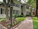Charming home featuring manicured landscaping, colorful flowers, and a brick pathway at 2417 Calais Pl, Charlotte, NC 28211