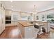 Open concept kitchen with wood and black countertops, ample storage, and unique chandelier lighting at 2417 Calais Pl, Charlotte, NC 28211
