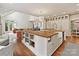 Large kitchen with stainless steel appliances, white cabinets, hardwood floors, and skylight features at 2417 Calais Pl, Charlotte, NC 28211