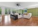 Bright living room featuring hardwood floors, green cabinets, and large windows letting in natural light at 2417 Calais Pl, Charlotte, NC 28211