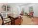 Office space with hardwood floors, built-in shelving, large desk, and ample natural light at 2417 Calais Pl, Charlotte, NC 28211