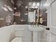 Charming powder room with an ornate mirror, pedestal sink, and unique underwater-themed wallpaper at 2417 Calais Pl, Charlotte, NC 28211