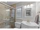 Cozy tiled bathroom featuring glass shower and natural light at 2418 Ainsdale Rd, Charlotte, NC 28226