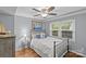 Comfortable bedroom features windows providing natural light, hardwood floors, and sailboat themed decorations at 2418 Ainsdale Rd, Charlotte, NC 28226