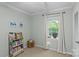 Bright bedroom with a window, playful decor, and a colorful bookcase filled with books at 2418 Ainsdale Rd, Charlotte, NC 28226