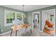 Dining area with a mid-century modern light fixture and a view to a bright laundry room at 2418 Ainsdale Rd, Charlotte, NC 28226