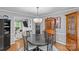 Open dining area featuring hardwood floors and views into the living room at 2418 Ainsdale Rd, Charlotte, NC 28226