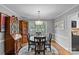 Formal dining room with a round table, elegant chandelier, and classic wooden furniture at 2418 Ainsdale Rd, Charlotte, NC 28226