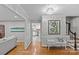 Elegant hallway showcasing hardwood floors, decorative lighting, and neutral wall colors at 2418 Ainsdale Rd, Charlotte, NC 28226