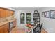 Well-lit home office with built-in cabinets, a work desk, and glass doors leading to the outdoors at 2418 Ainsdale Rd, Charlotte, NC 28226