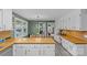 Spacious kitchen showcases white cabinets, butcher block countertops, stainless steel appliances, and hardwood style floors at 2418 Ainsdale Rd, Charlotte, NC 28226