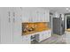 Well-appointed kitchen with white cabinets, butcher block counters, stainless appliances, and wood-look flooring at 2418 Ainsdale Rd, Charlotte, NC 28226