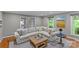 Comfortable living room with a large sectional sofa and serene green outdoor views at 2418 Ainsdale Rd, Charlotte, NC 28226