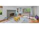Bright living room with a fireplace, wood floors, and large windows providing ample light at 2418 Ainsdale Rd, Charlotte, NC 28226