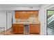 Convenient wet bar with stylish cabinetry, countertop, wine cooler, and easy access to the outside at 2418 Ainsdale Rd, Charlotte, NC 28226