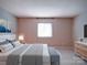 Comfortable bedroom features a plush bed, soft carpet, and dresser with a television at 2900 #G Heathstead Pl, Charlotte, NC 28210