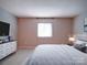 Cozy bedroom with neutral tones, soft carpet, and dresser with a television at 2900 #G Heathstead Pl, Charlotte, NC 28210