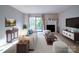 Bright living room features a fireplace, plush carpet, and access to an outdoor balcony with natural light at 2900 #G Heathstead Pl, Charlotte, NC 28210