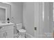 A neutral colored bathroom featuring a toilet, sink and marble floors at 3075 Jamestown Dr, Gastonia, NC 28054