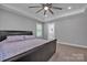 Neutral bedroom boasts a modern platform bed and a glimpse into an ensuite bathroom, offering comfort at 3075 Jamestown Dr, Gastonia, NC 28054
