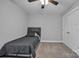 A bedroom featuring gray carpet, a black bed, a ceiling fan and a closet at 3075 Jamestown Dr, Gastonia, NC 28054