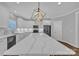 This kitchen has a large island with black stainless steel appliances and modern light fixtures at 3075 Jamestown Dr, Gastonia, NC 28054